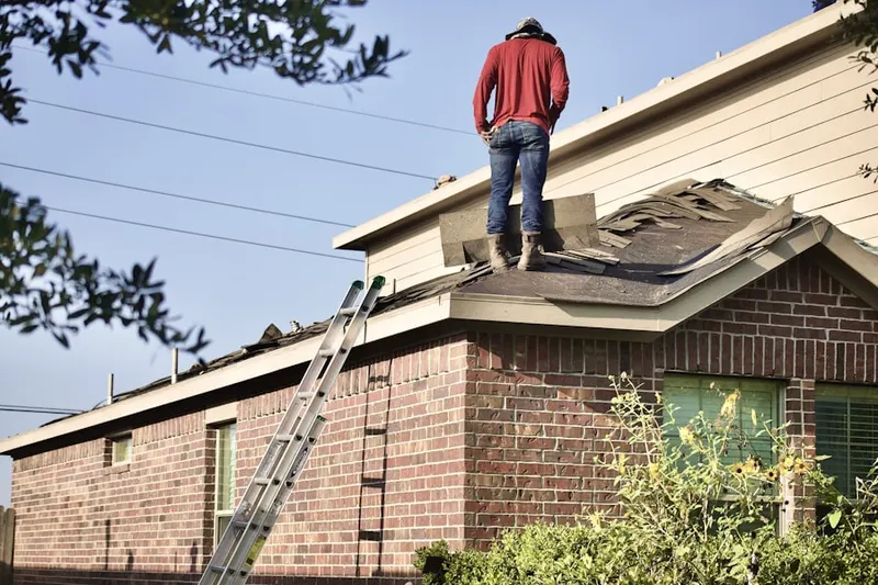 Professional roofer working on a residential roof in North Harford Heights